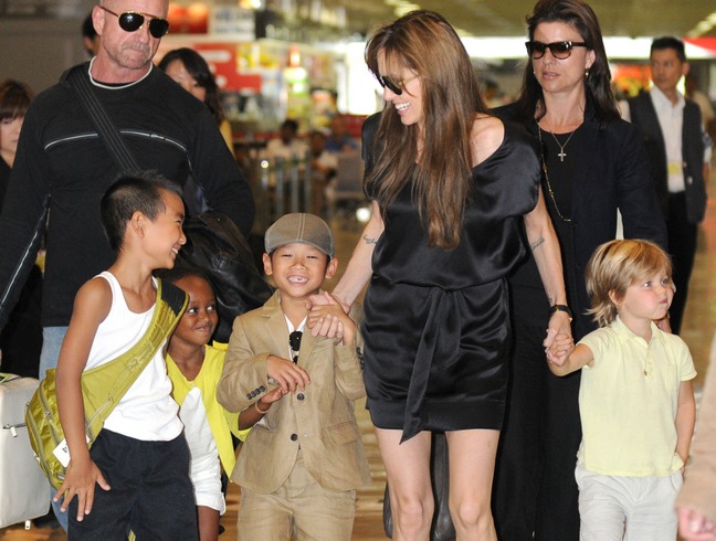 Angelina Jolie, flip flops, sunglasses, black silk minidress